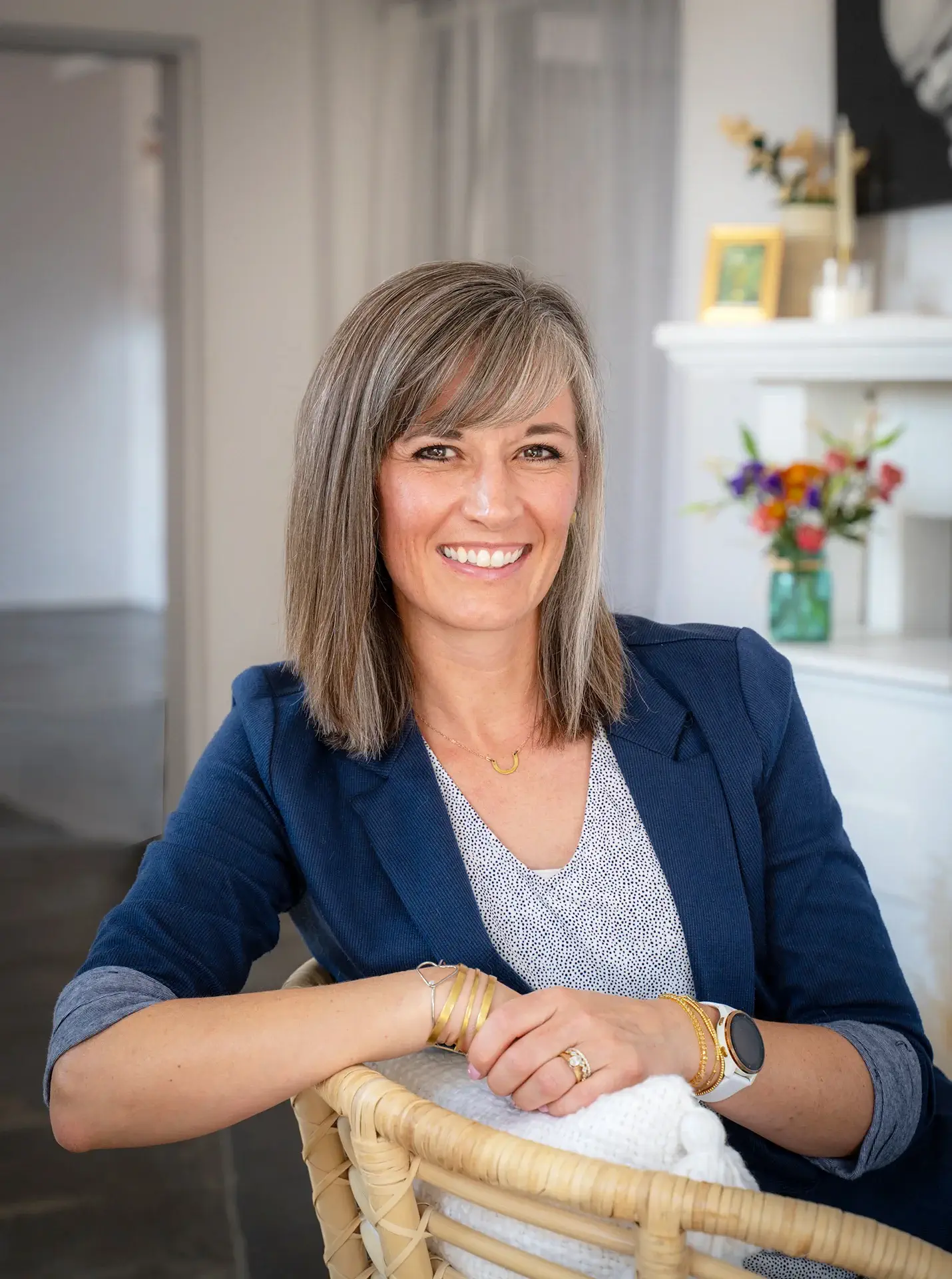 Dr. Amber Ingersoll smiling and sitting in a light, modern room.